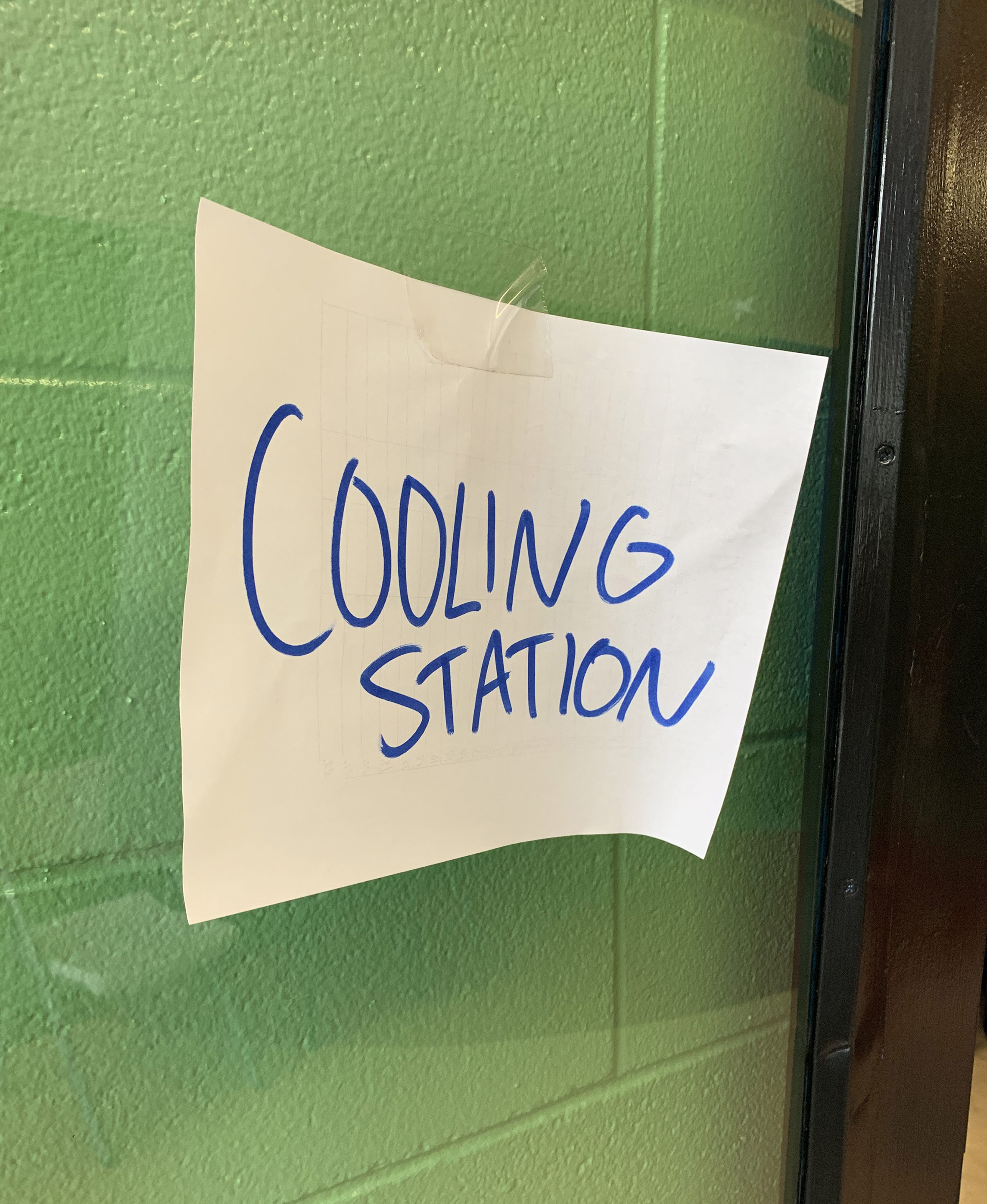 A photo of a piece of paper with writing that reads, "Cooling station."